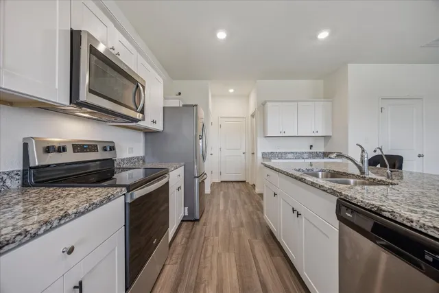 a large kitchen with sink and cabinets