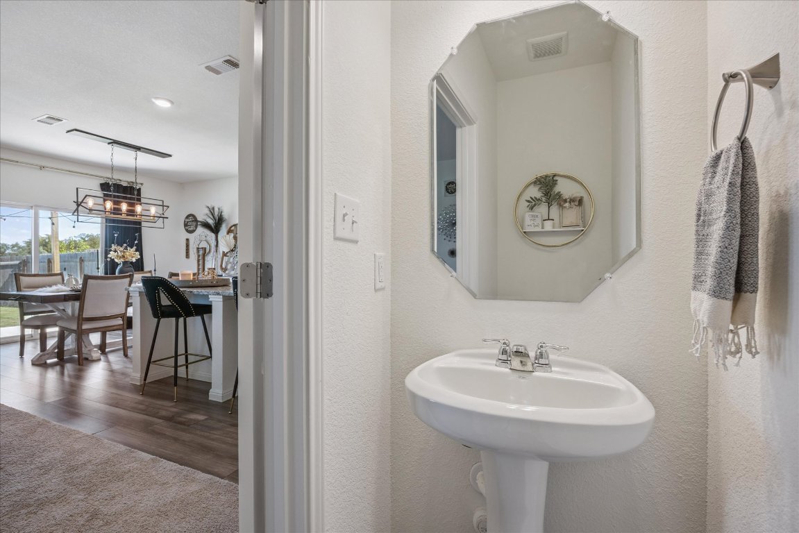 208 Night Riders Way Jarrell, TX 76537 - Photo 13 of 31 a bathroom with a sink and a mirror