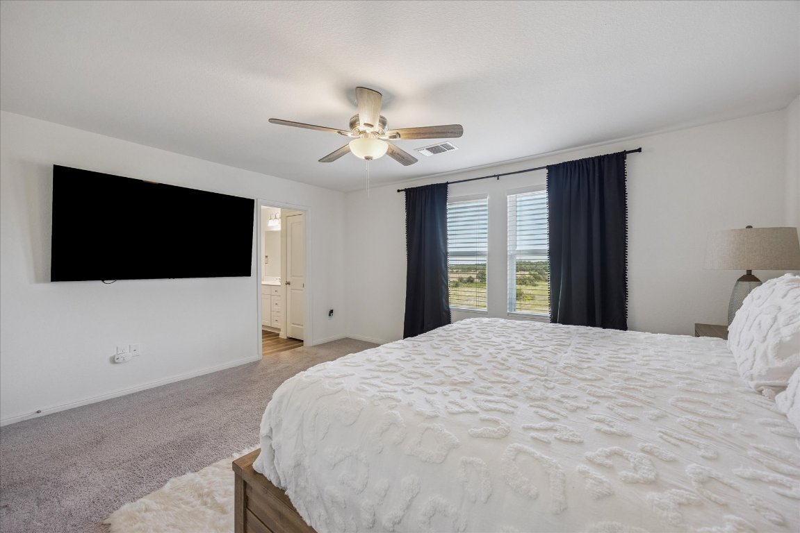 208 Night Riders Way Jarrell, TX 76537 - Photo 15 of 31 a bedroom with a bed tv and a window