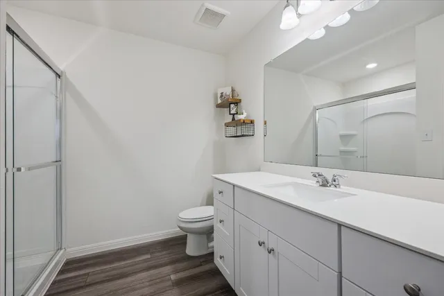 a bedroom with a bed tv and a window