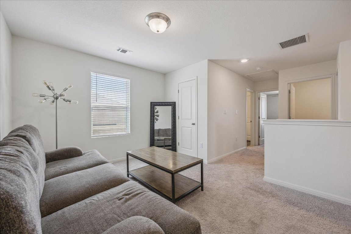 208 Night Riders Way Jarrell, TX 76537 - Photo 17 of 31 a living room with furniture and a window