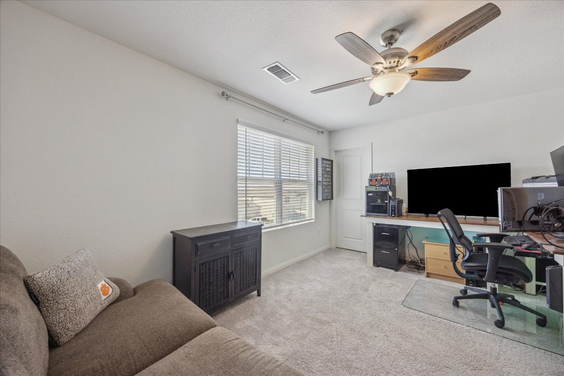 208 Night Riders Way Jarrell, TX 76537 - Photo 20 of 31 a living room with furniture and a flat screen tv