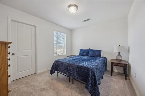 a bedroom with a bed and window