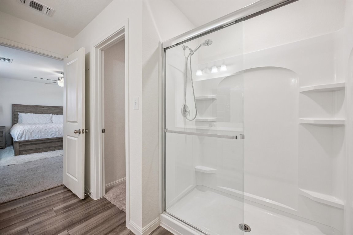208 Night Riders Way Jarrell, TX 76537 - Photo 24 of 31 a bathroom with a glass shower door and a sink