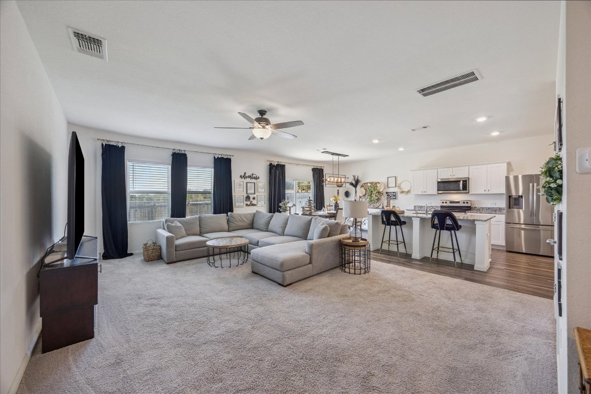208 Night Riders Way Jarrell, TX 76537 - Photo 3 of 31 a living room with furniture and a flat screen tv