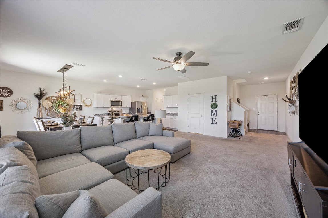 208 Night Riders Way Jarrell, TX 76537 - Photo 4 of 31 a living room with furniture kitchen and a chandelier