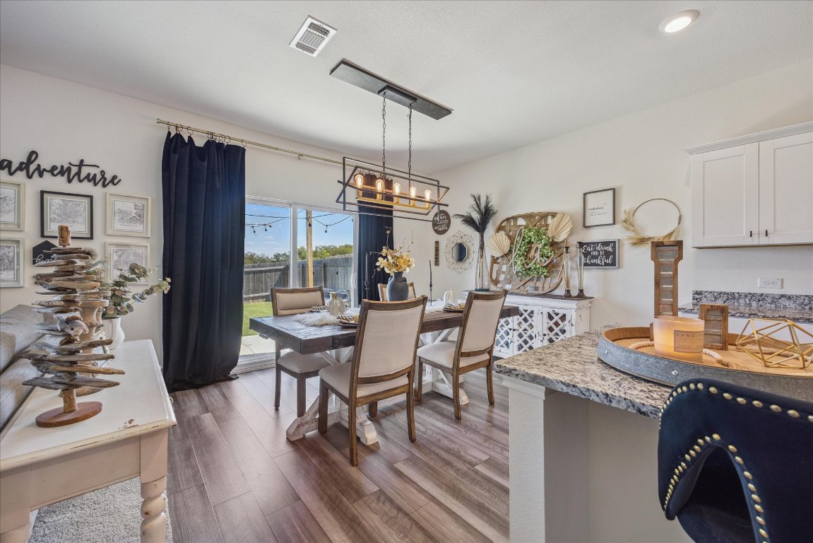 208 Night Riders Way Jarrell, TX 76537 - Photo 8 of 31 a kitchen with sink refrigerator dining table and chairs