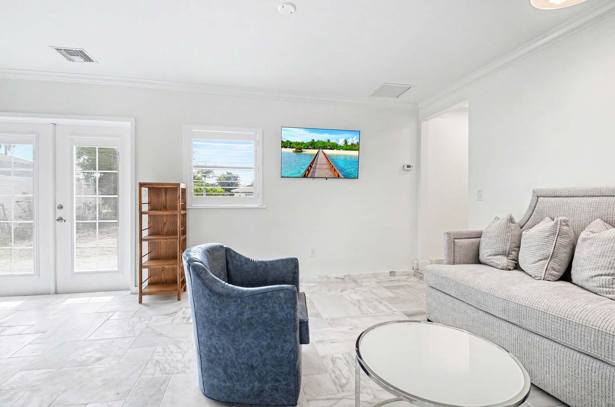 112 Capri Boulevard Naples, FL 34113 - Photo 14 of 29 a living room with furniture and a couch