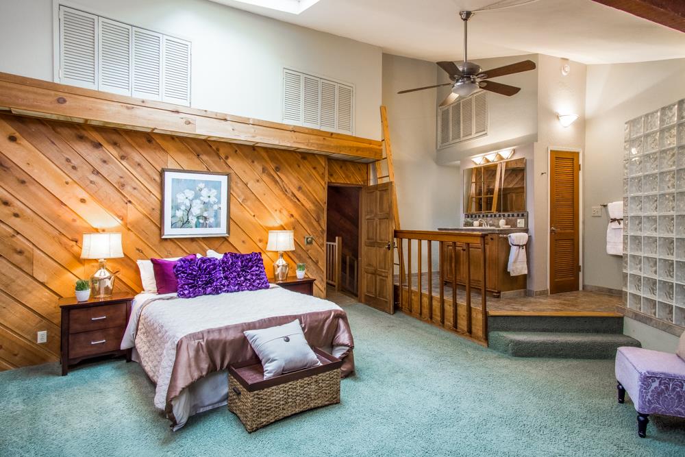 661 Sugar Pine Road Scotts Valley, CA 95066 - Photo 20 of 40 a bedroom with a bed and a chandelier