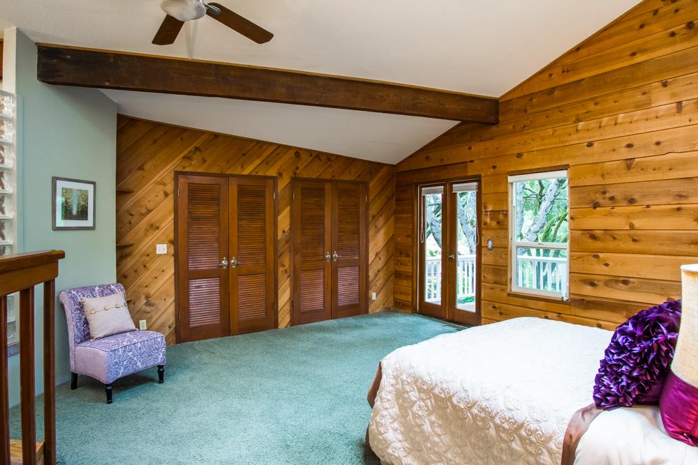 661 Sugar Pine Road Scotts Valley, CA 95066 - Photo 21 of 40 a bedroom with a bed and wooden floor