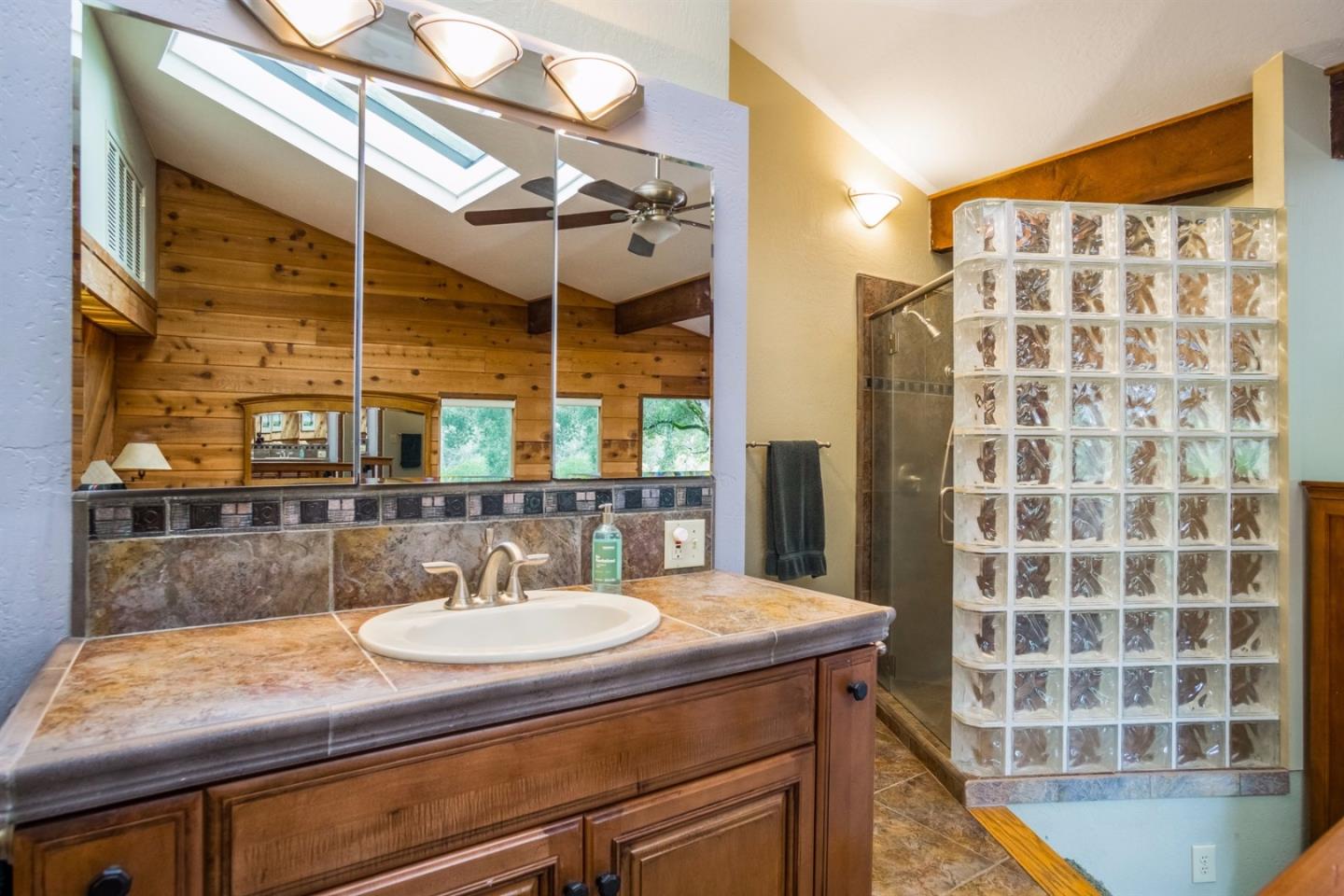 661 Sugar Pine Road Scotts Valley, CA 95066 - Photo 22 of 40 a bathroom with a sink and a mirror