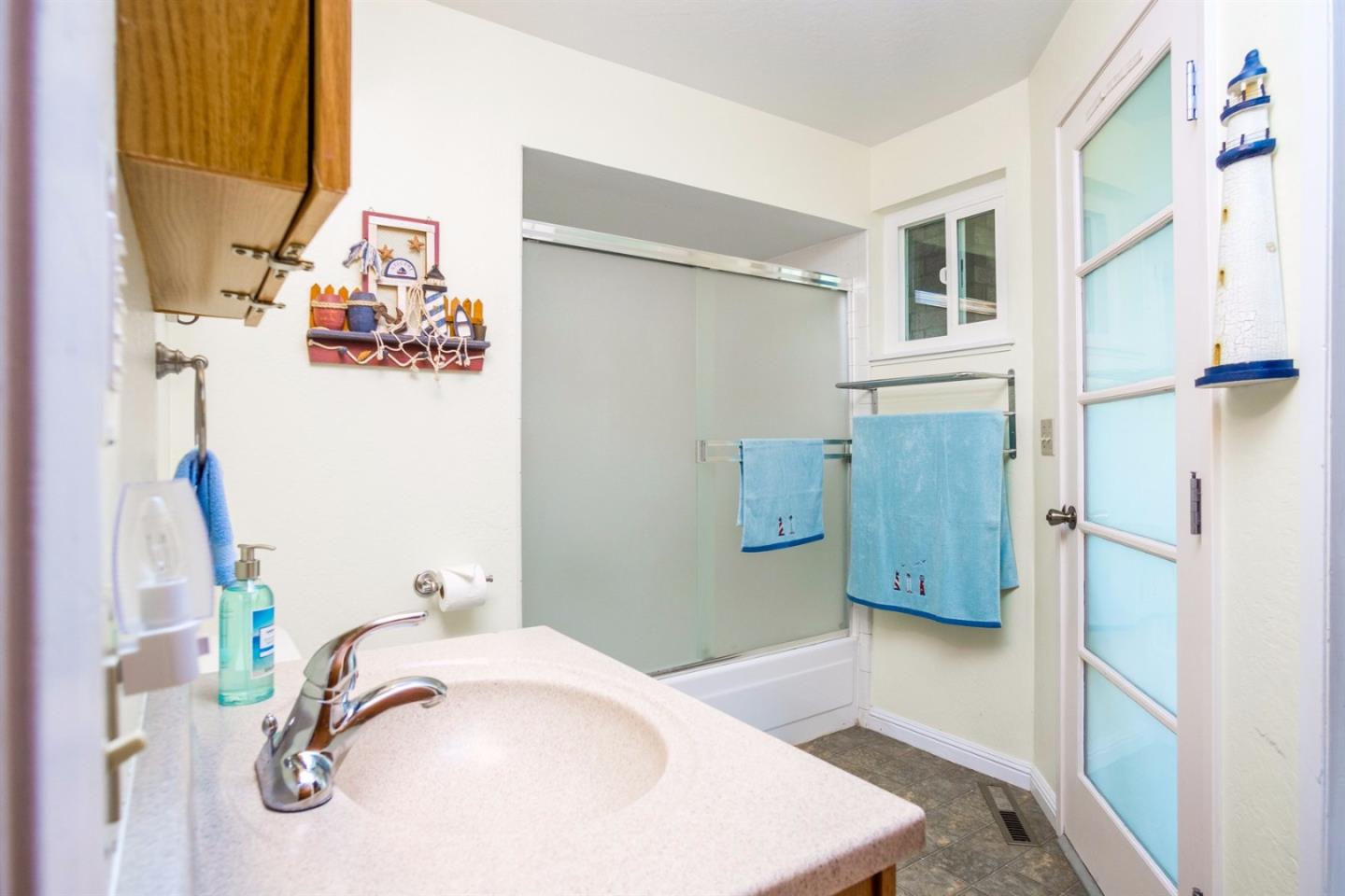 661 Sugar Pine Road Scotts Valley, CA 95066 - Photo 30 of 40 a bathroom with a tub sink and mirror