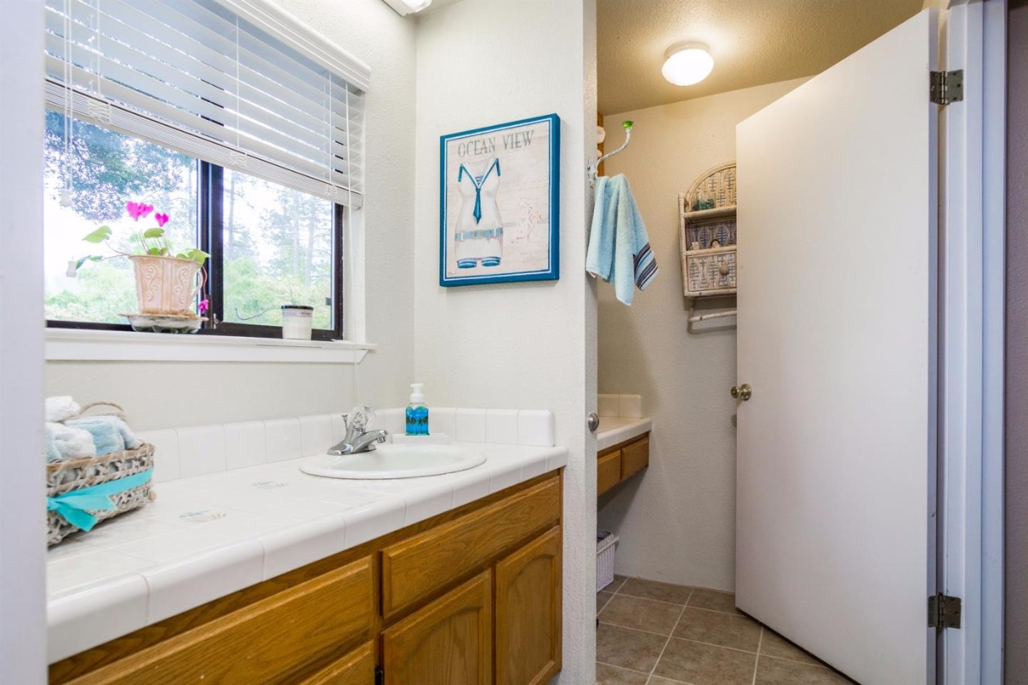 661 Sugar Pine Road Scotts Valley, CA 95066 - Photo 32 of 40 a bathroom with a sink mirror and window