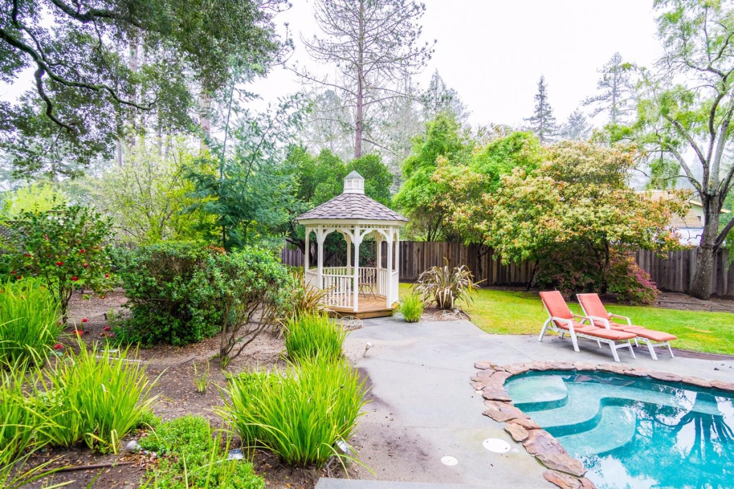 661 Sugar Pine Road Scotts Valley, CA 95066 - Photo 10 of 40 a front view of a house with a yard table and chairs