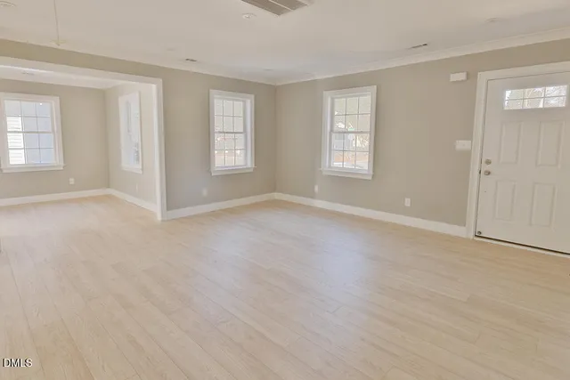 an empty room with wooden floor and closet