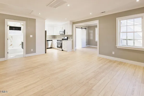 a view of a kitchen with wooden floor and a kitchen
