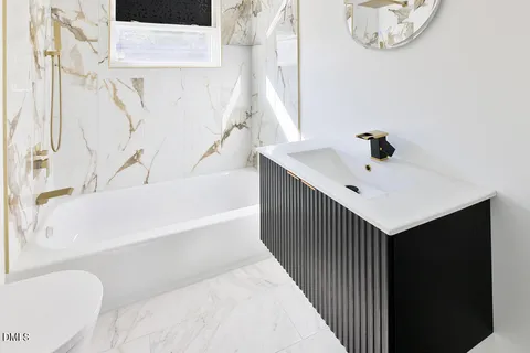 a bathroom with a bathtub and a shower