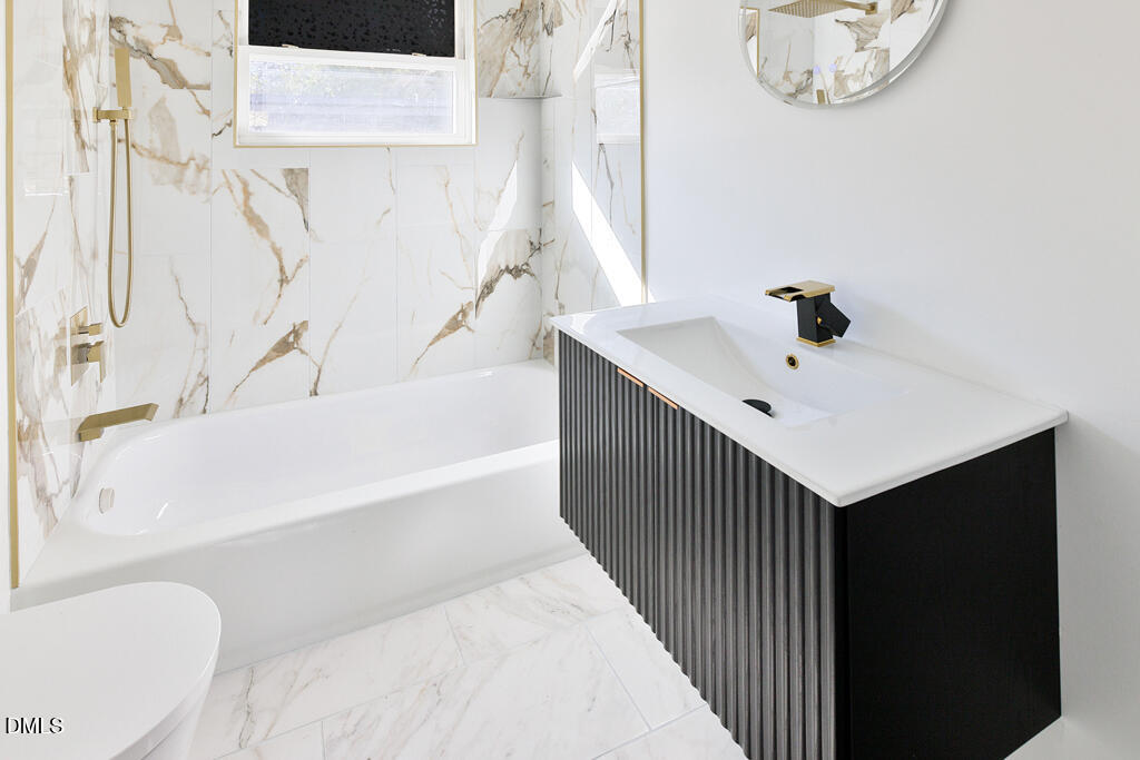 917 Gold Street North Wilson, NC 27893 - Photo 8 of 41 a bathroom with a bathtub sink and mirror