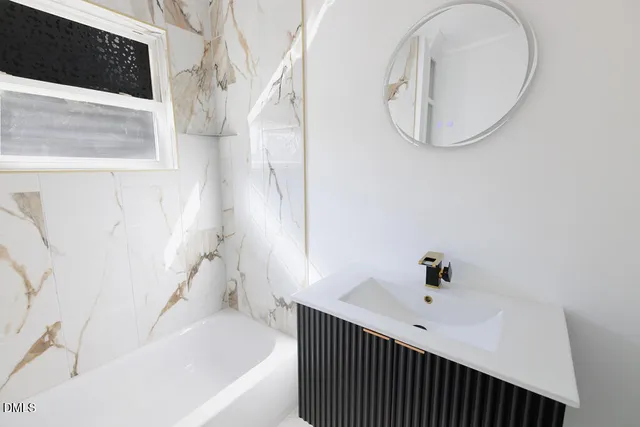 a bath tub sitting next to a white sink