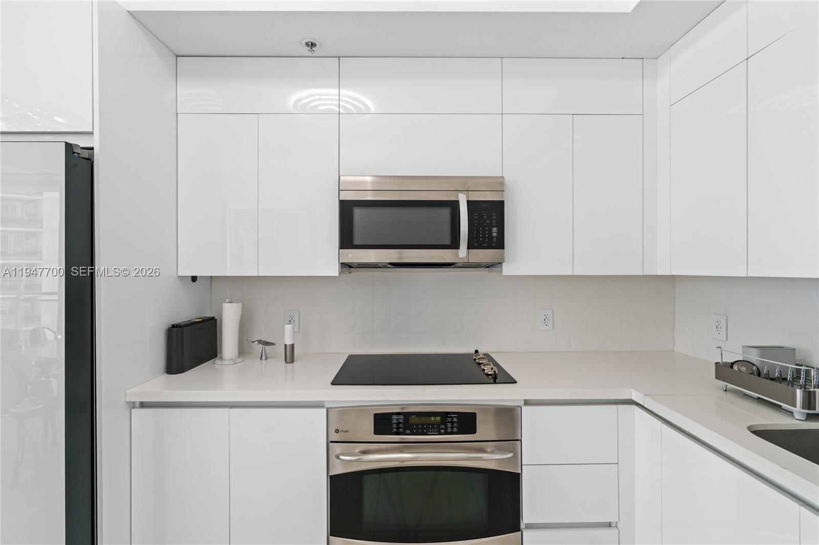 90 Southwest 3rd Street, Unit 2204 Miami, FL 33130 - Photo 12 of 51 a kitchen with a stove and a microwave