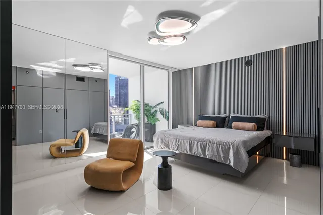 a bedroom with a bed and chandelier