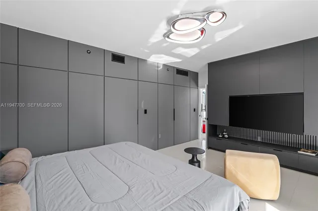 a bedroom with a bed and a flat screen tv