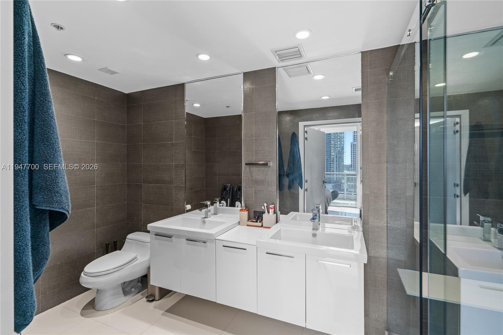 90 Southwest 3rd Street, Unit 2204 Miami, FL 33130 - Photo 22 of 51 a bathroom with a sink toilet and shower