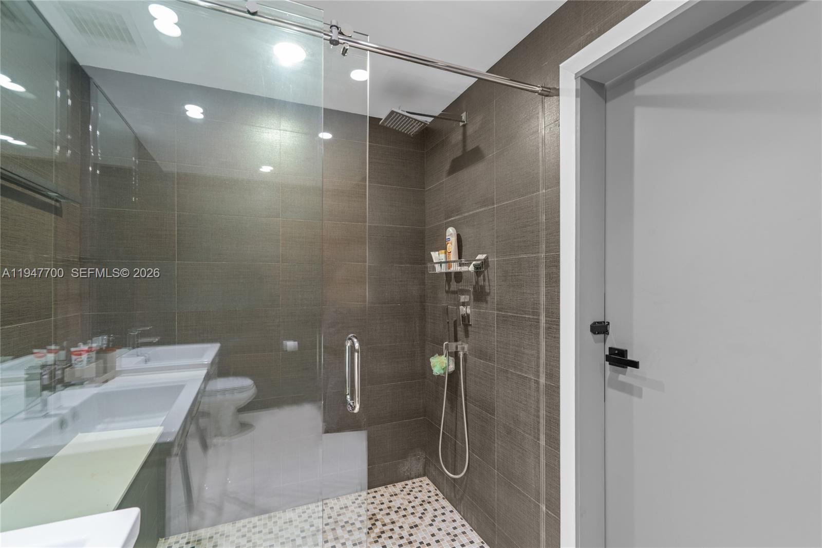 90 Southwest 3rd Street, Unit 2204 Miami, FL 33130 - Photo 24 of 51 a bathroom with a sink a toilet and shower