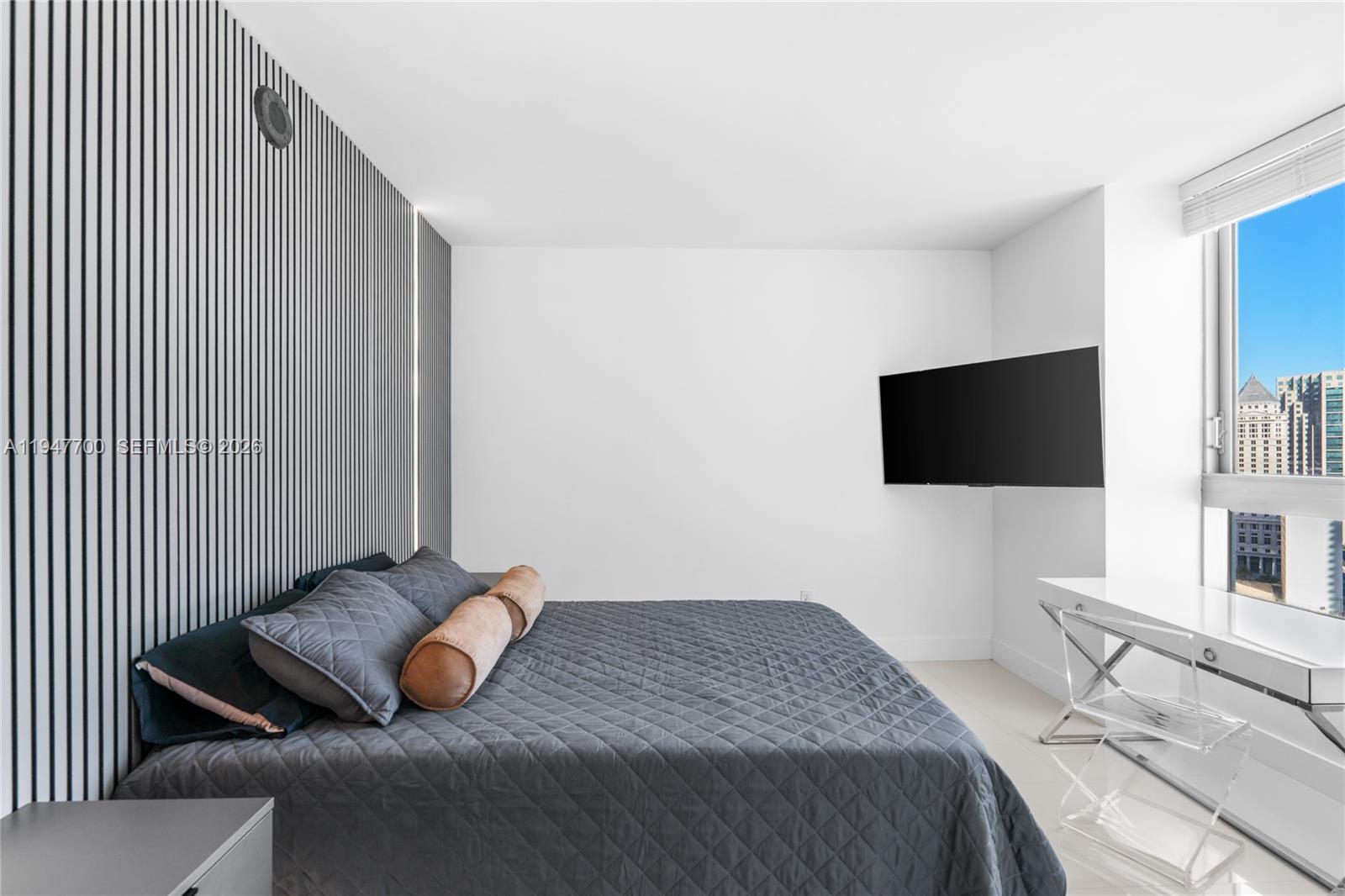 90 Southwest 3rd Street, Unit 2204 Miami, FL 33130 - Photo 26 of 51 a bedroom with a bed and a flat screen tv