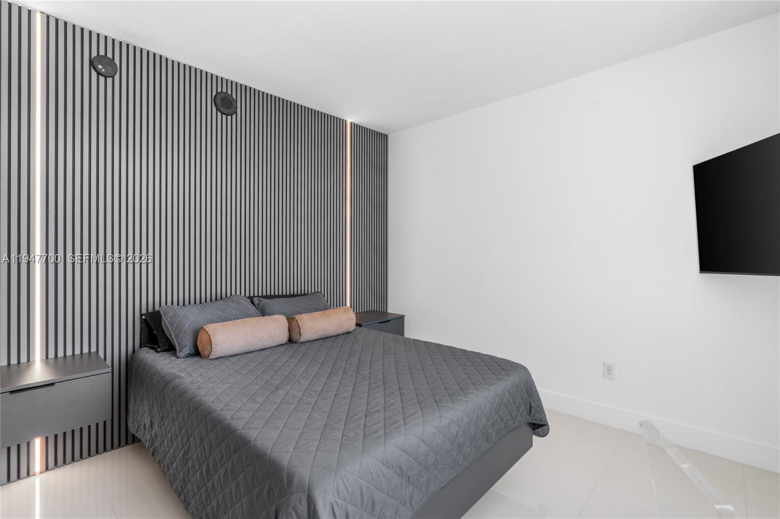 90 Southwest 3rd Street, Unit 2204 Miami, FL 33130 - Photo 27 of 51 a bedroom with a bed and a flat screen tv