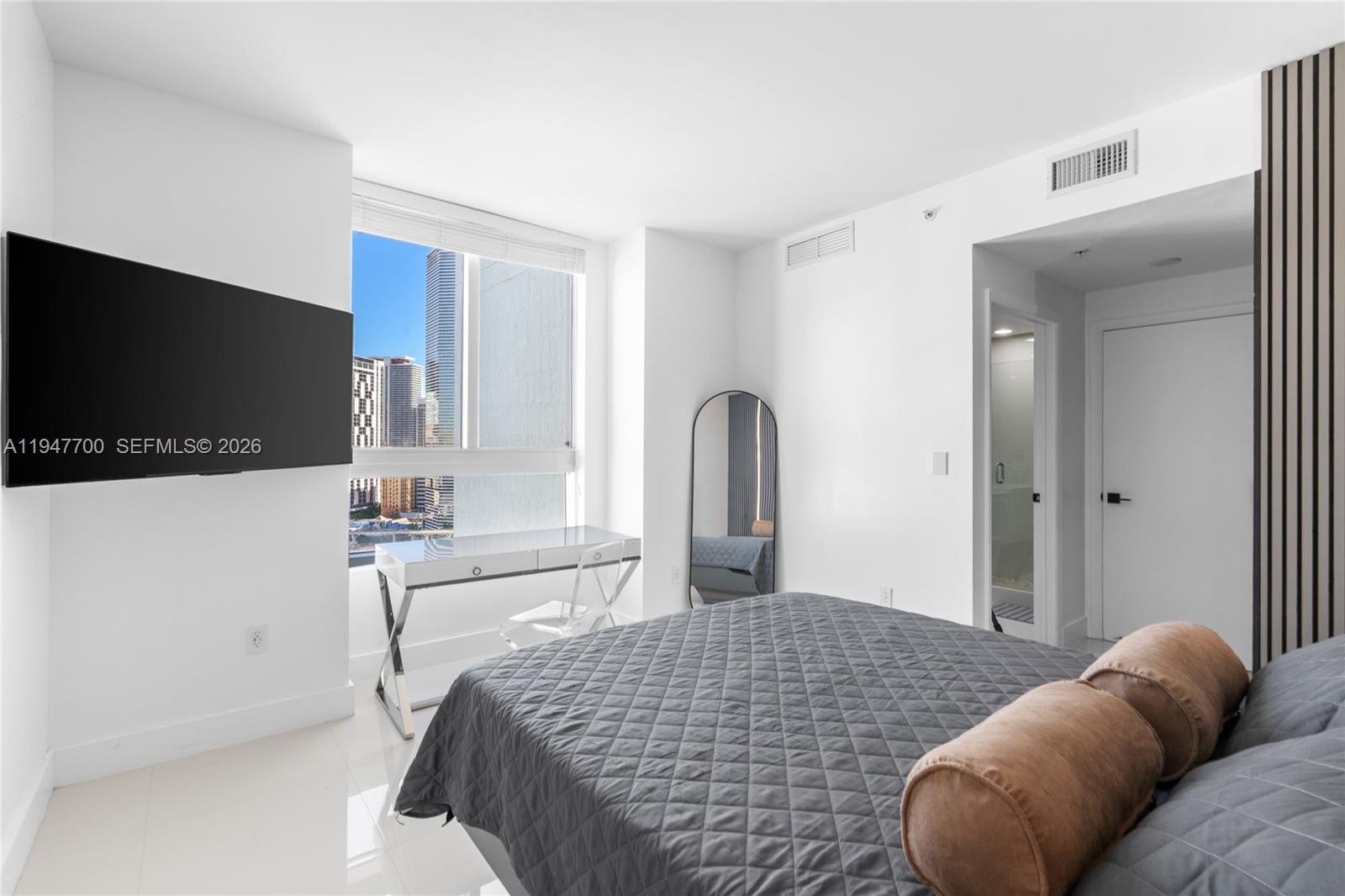 90 Southwest 3rd Street, Unit 2204 Miami, FL 33130 - Photo 29 of 51 a bedroom with a bed and a flat screen tv