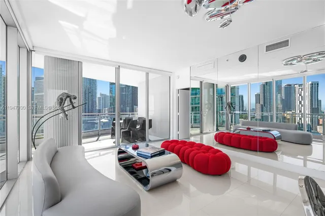 a bedroom with furniture and a large window