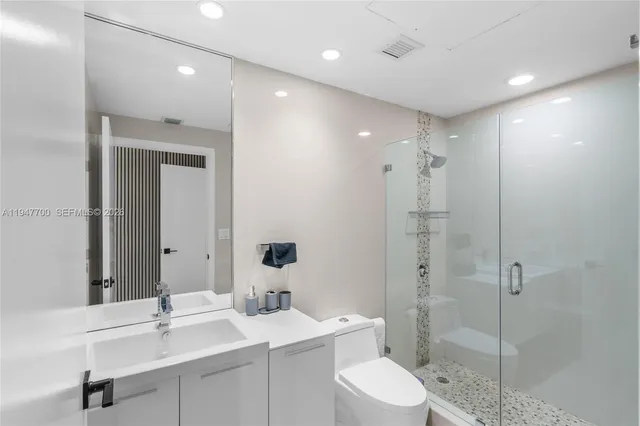 a bathroom with a shower a toilet and sink