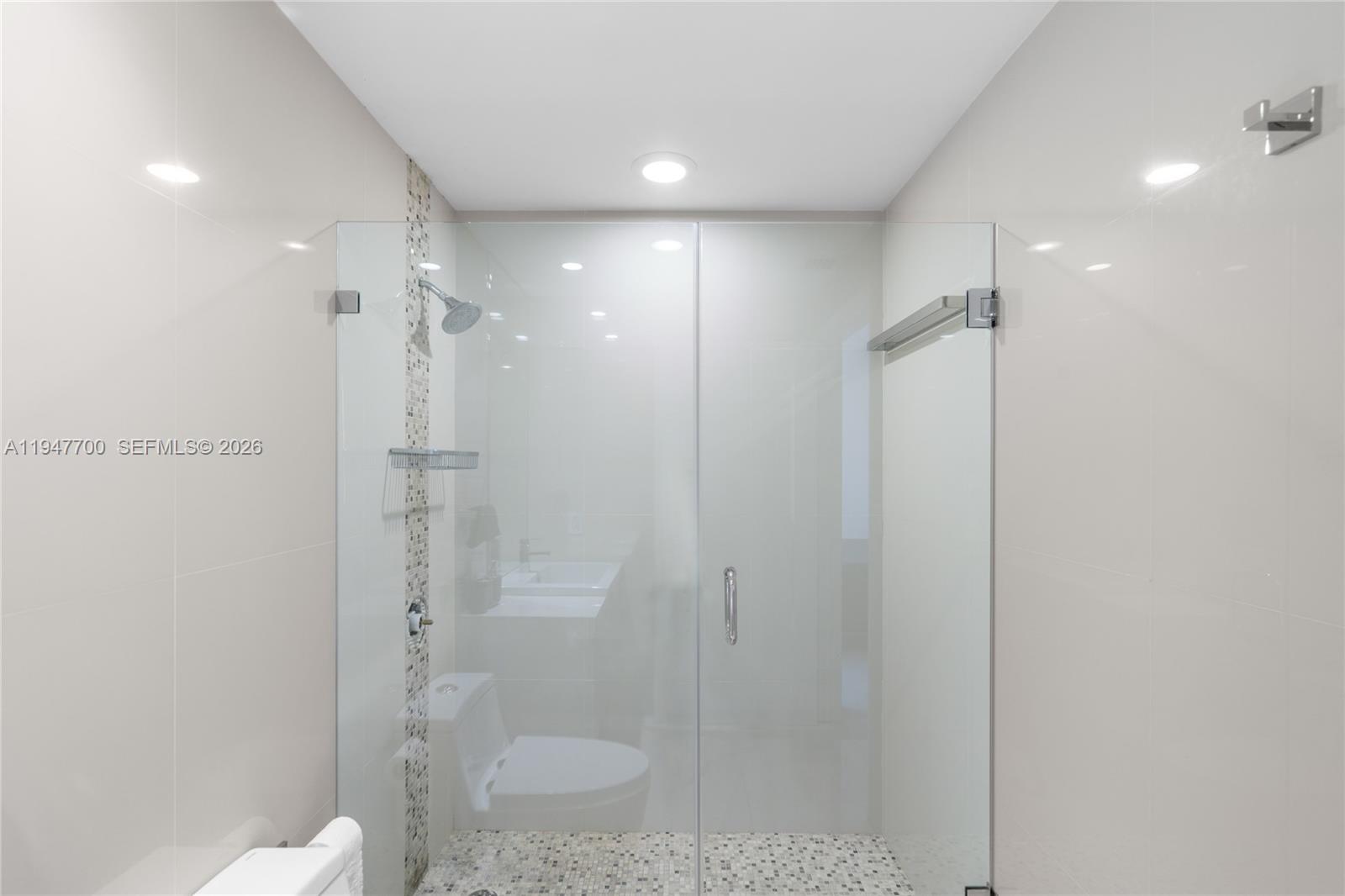 90 Southwest 3rd Street, Unit 2204 Miami, FL 33130 - Photo 37 of 51 a bathroom with a shower a toilet and sink