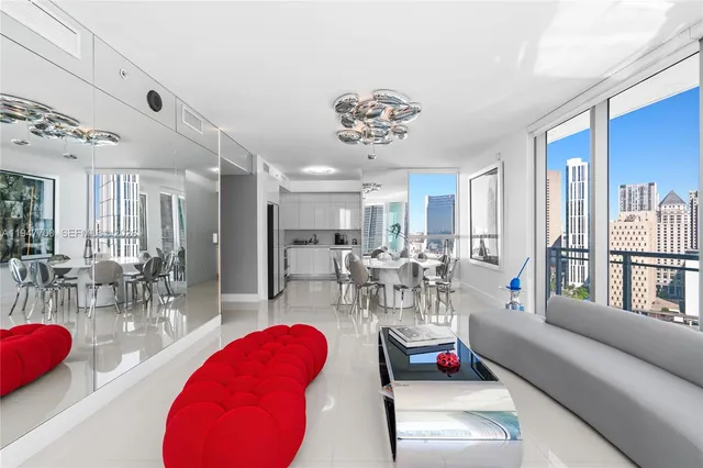 a living room with furniture a table and chairs