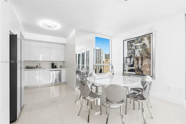 a dining room with furniture and view of kitchen
