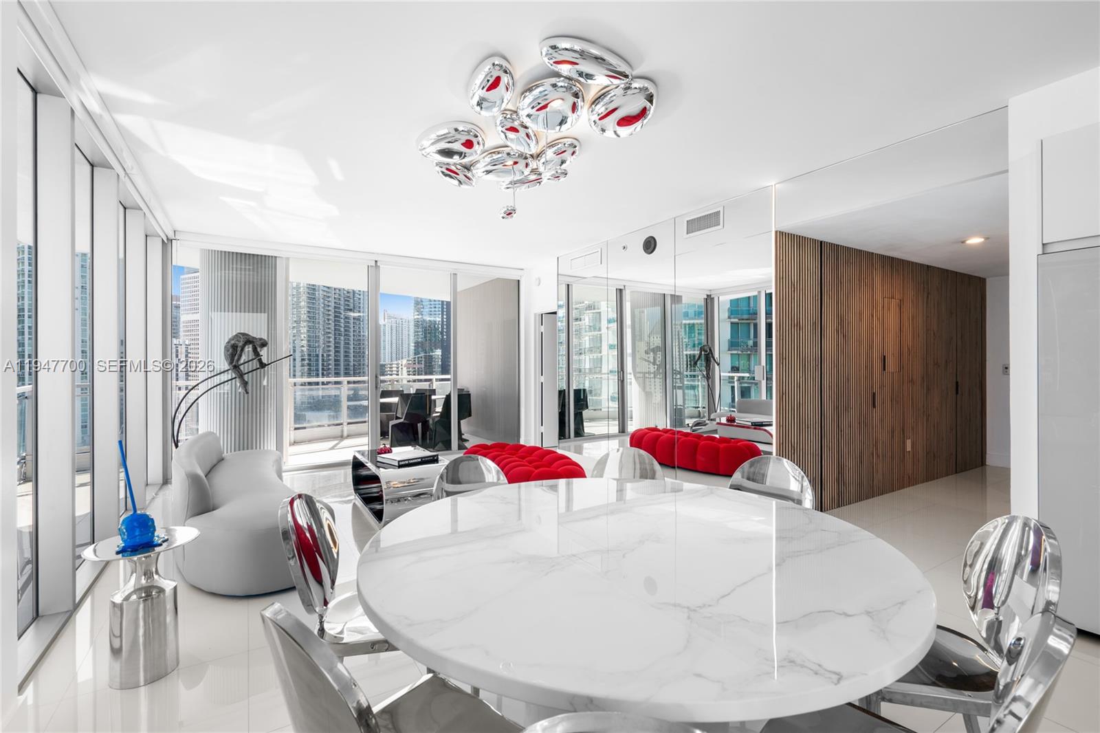 90 Southwest 3rd Street, Unit 2204 Miami, FL 33130 - Photo 9 of 51 a very nice looking bedroom with a large bed and a chandelier
