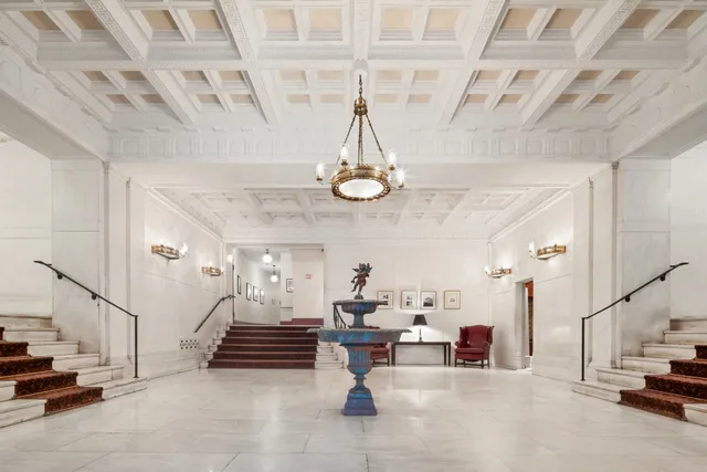 a view of hall way with furniture and stairs