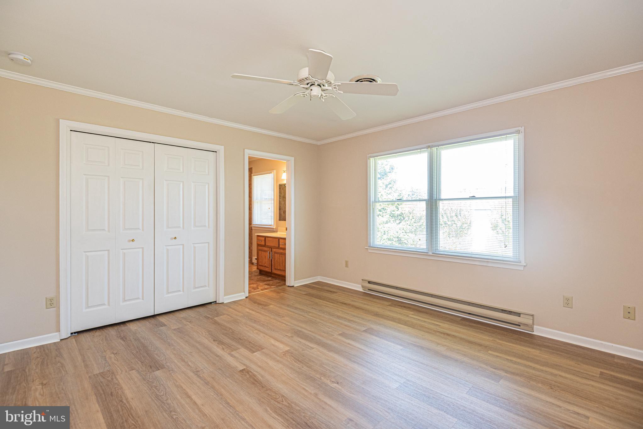 38241 Marlington Road Ocean View, DE 19970 - Photo 16 of 40 a view of an empty room with wooden floor and a window