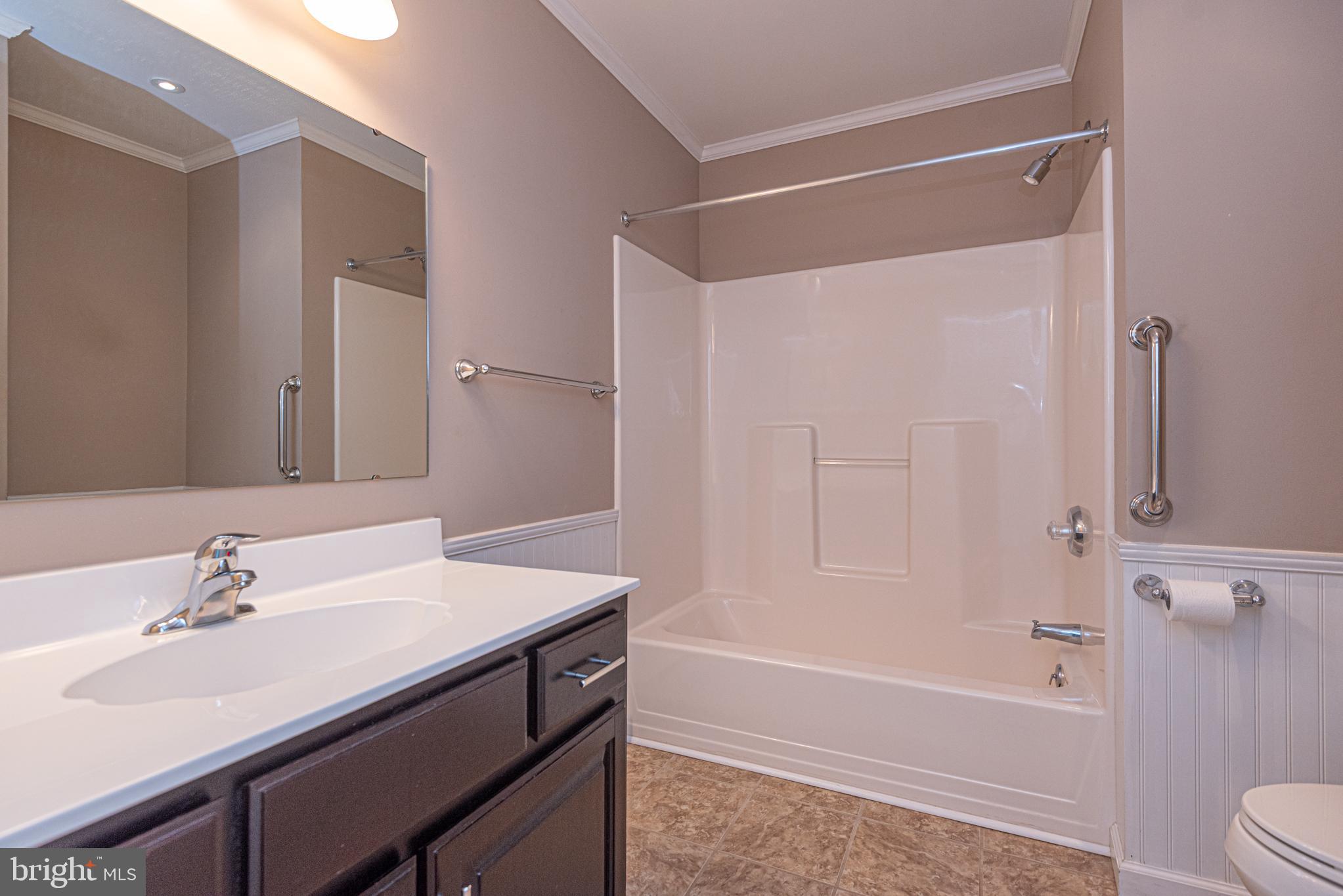 38241 Marlington Road Ocean View, DE 19970 - Photo 20 of 40 a bathroom with a sink a toilet and shower