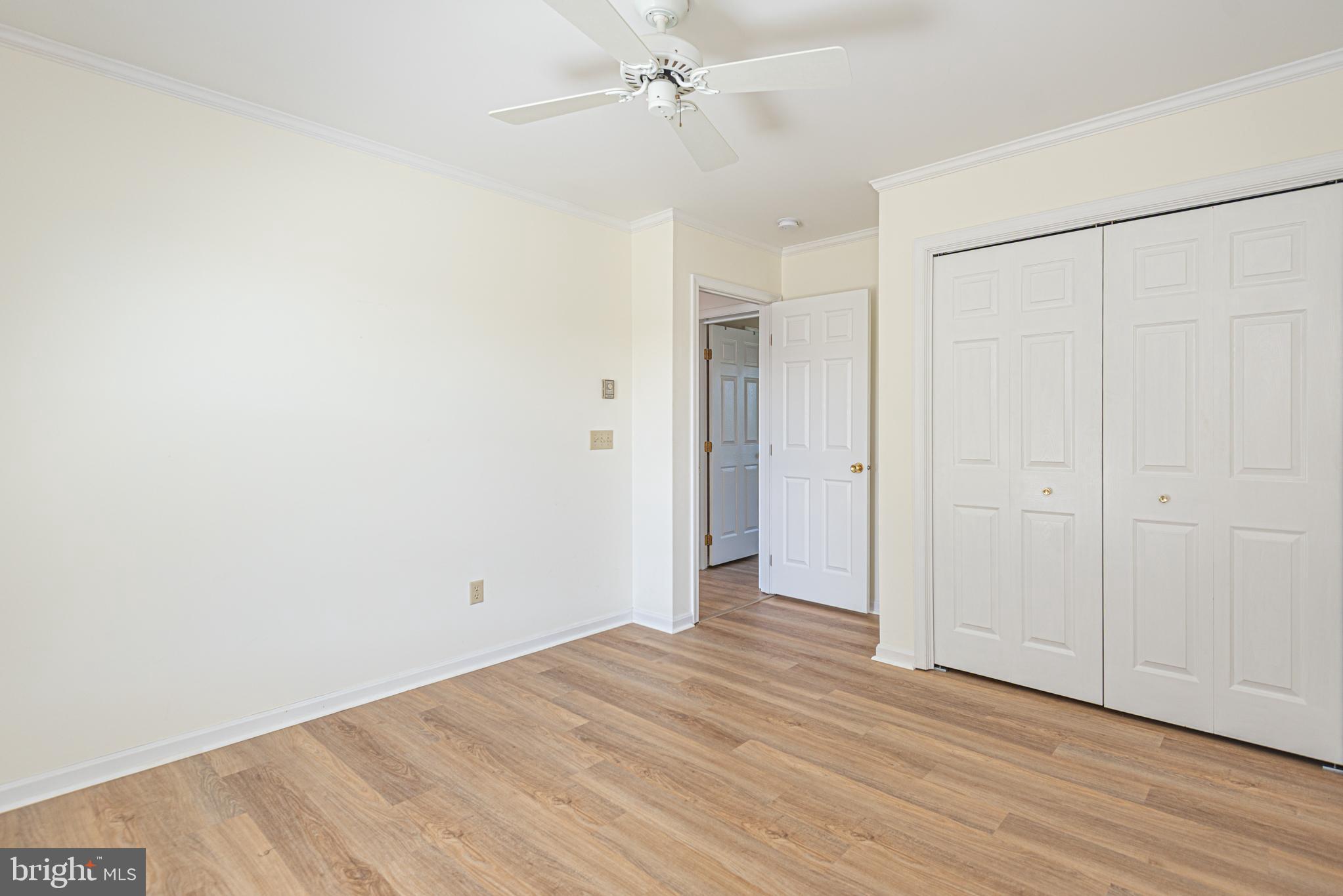 38241 Marlington Road Ocean View, DE 19970 - Photo 22 of 40 an empty room with wooden floor and ceiling fan