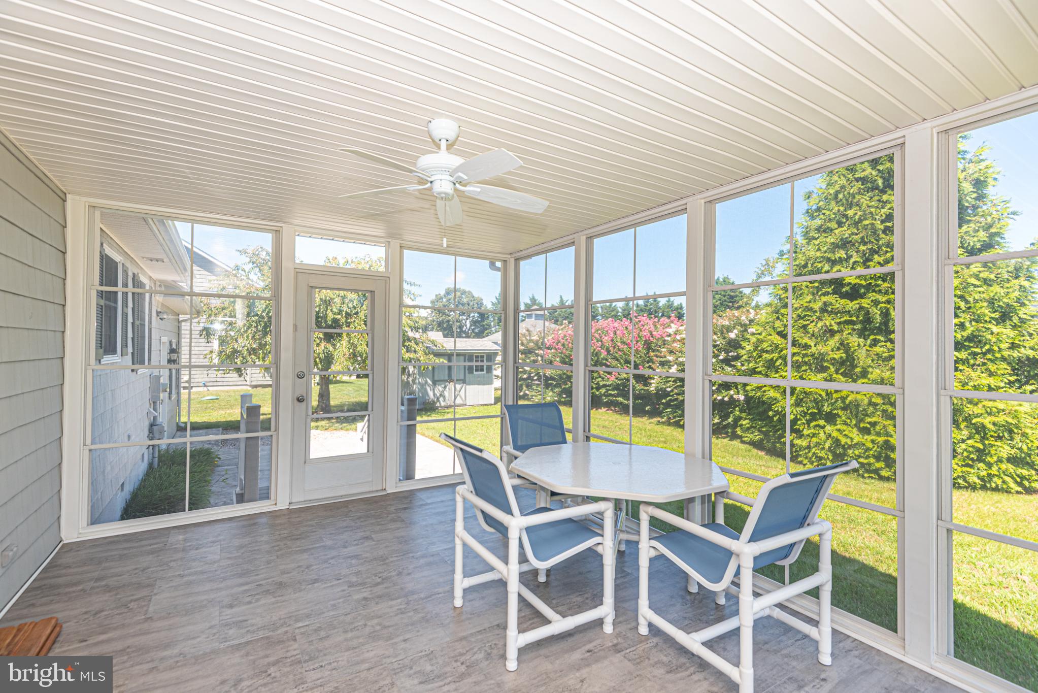 38241 Marlington Road Ocean View, DE 19970 - Photo 26 of 40 a view of a dining room with furniture a chandelier and wooden floor