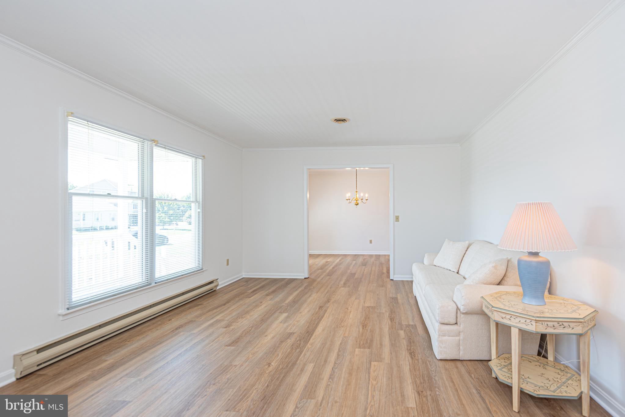 38241 Marlington Road Ocean View, DE 19970 - Photo 6 of 40 a view of a room with wooden floor white walls and windows