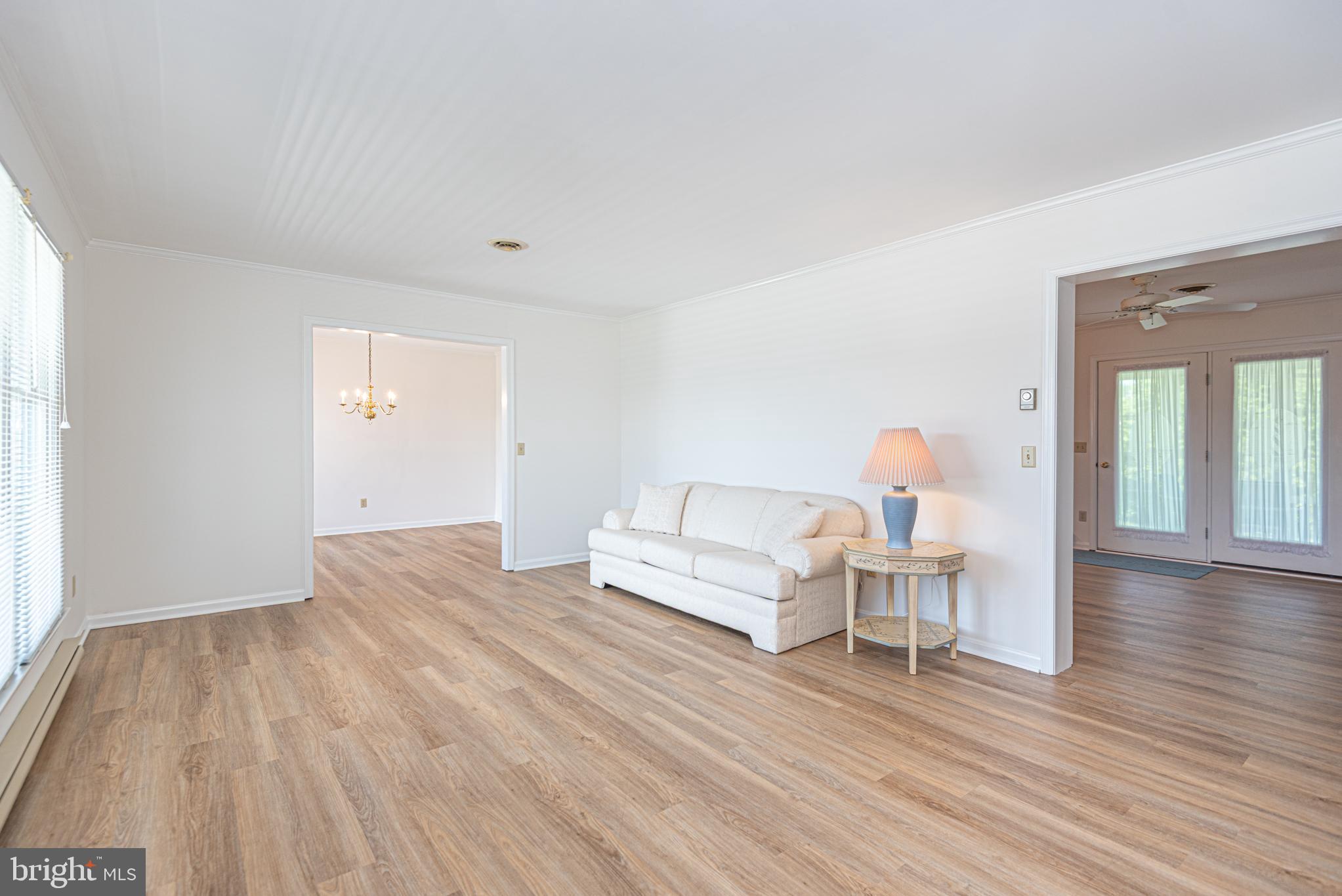 38241 Marlington Road Ocean View, DE 19970 - Photo 7 of 40 a living room with furniture and wooden floor