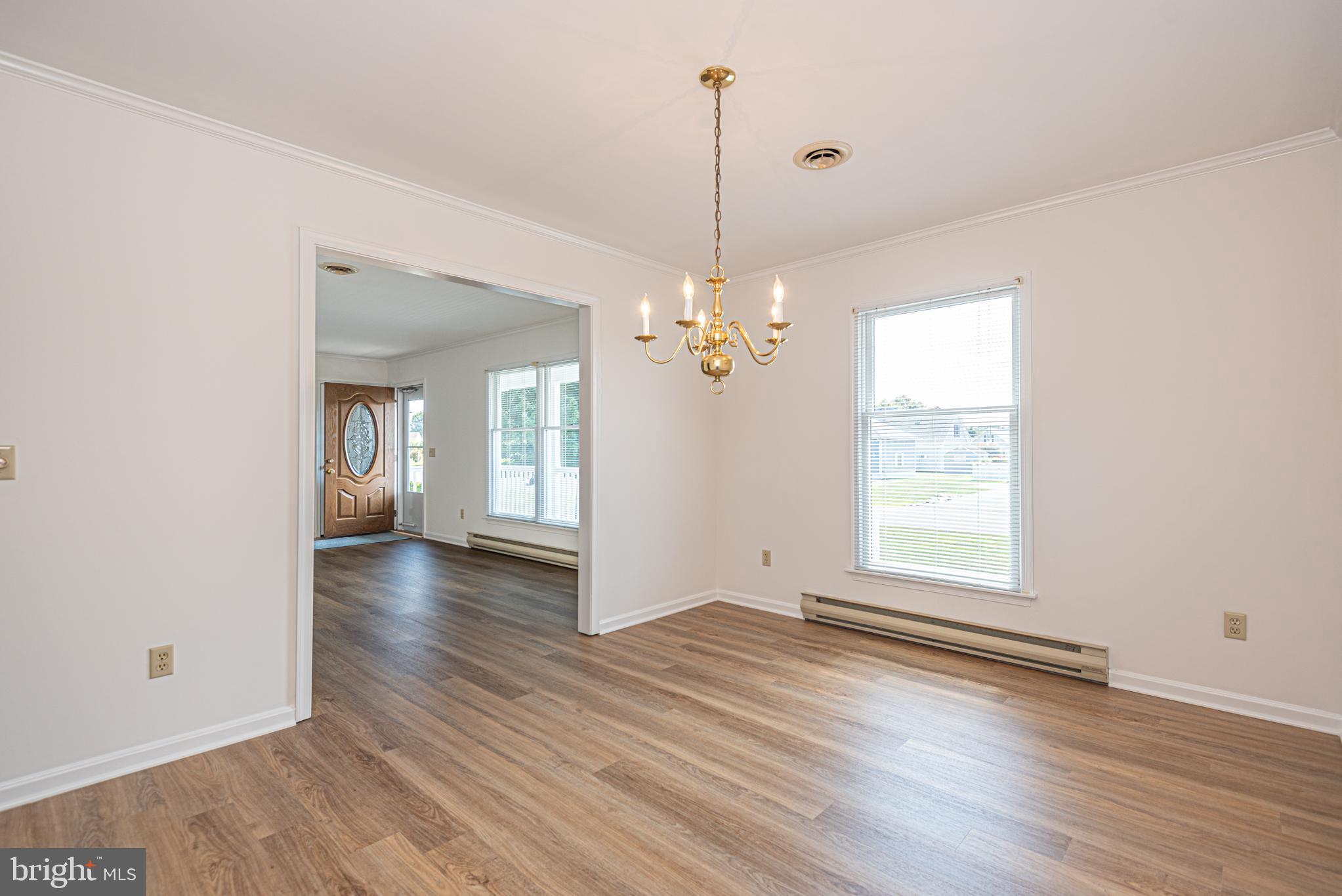 38241 Marlington Road Ocean View, DE 19970 - Photo 8 of 40 an empty room with wooden floor and windows