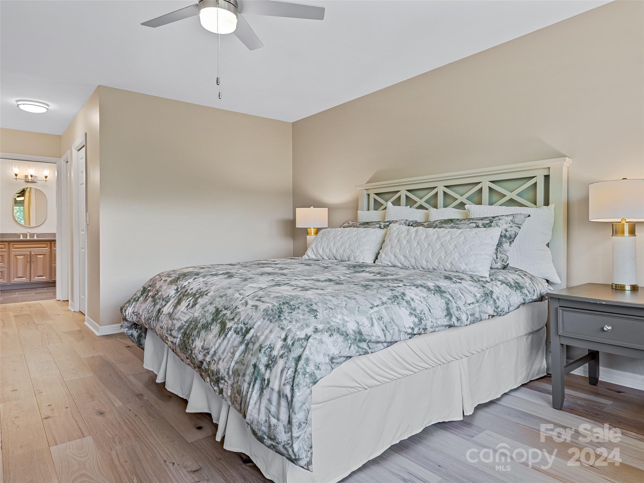 36 Stony Ridge Asheville, NC 28804 - Photo 30 of 38 a bedroom with a large bed and a chandelier