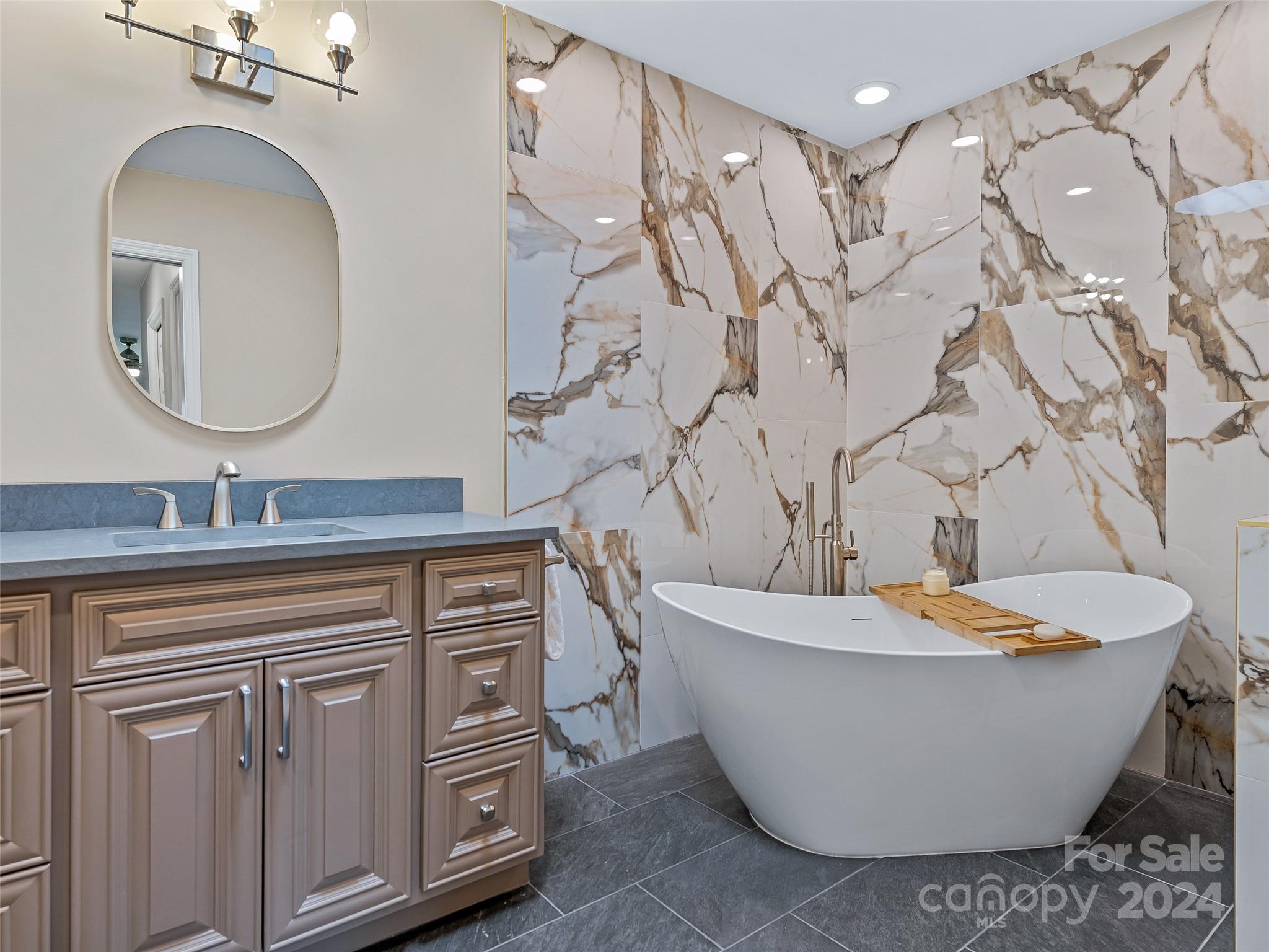 36 Stony Ridge Asheville, NC 28804 - Photo 33 of 38 a spacious bathroom with a tub sink and mirror