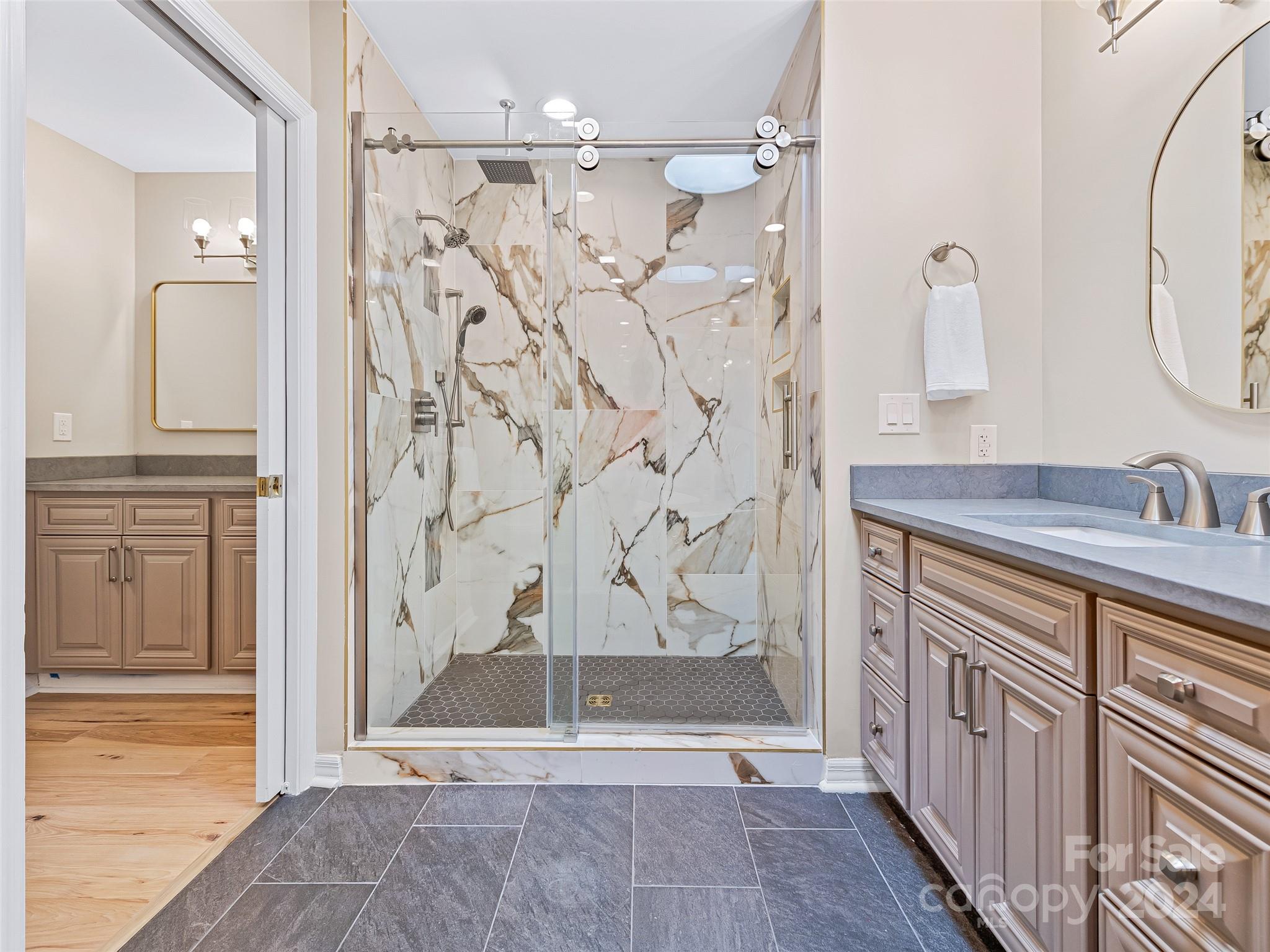 36 Stony Ridge Asheville, NC 28804 - Photo 34 of 38 a bathroom with a granite countertop sink a mirror and shower