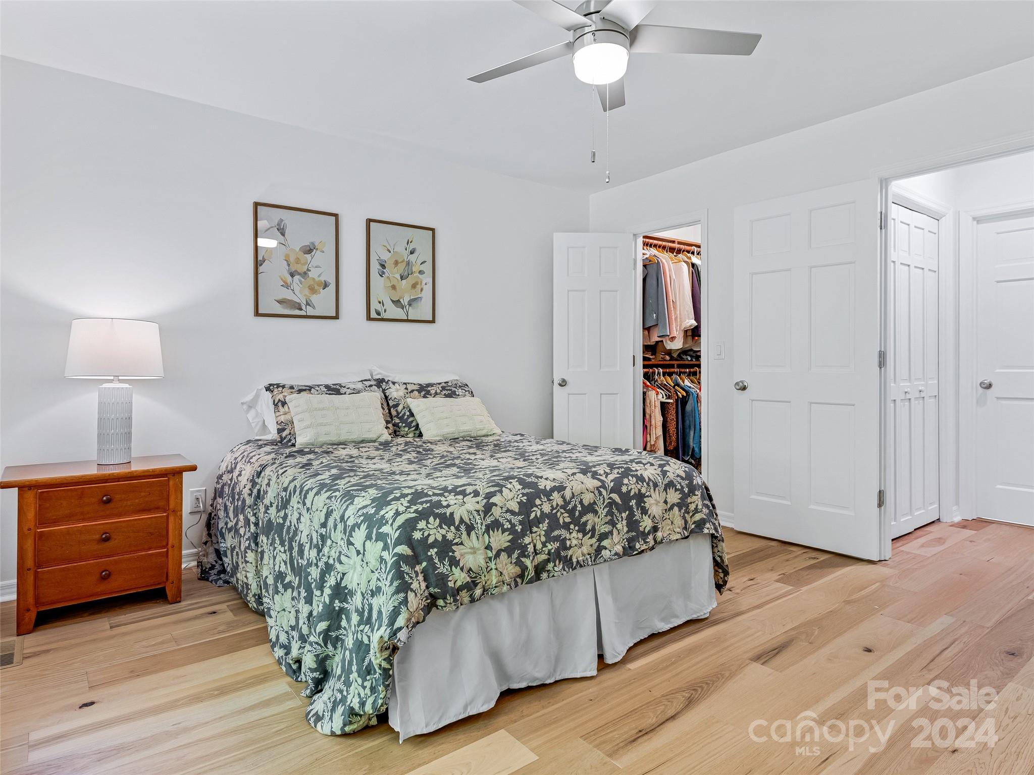 36 Stony Ridge Asheville, NC 28804 - Photo 36 of 38 a bedroom with a bed and a chandelier