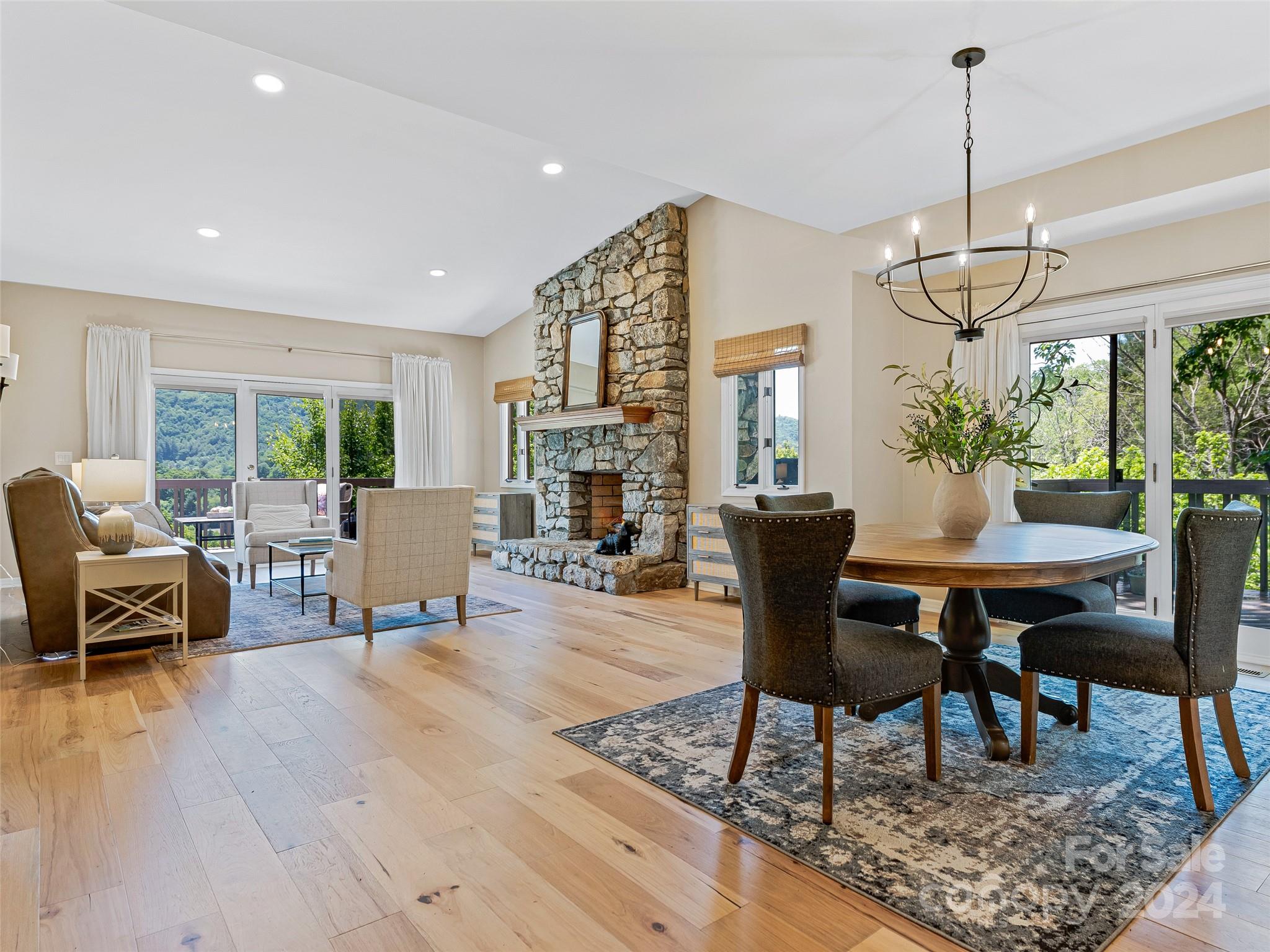 36 Stony Ridge Asheville, NC 28804 - Photo 6 of 38 a dining room with wooden floor a chandelier a wooden table and chairs